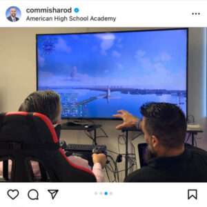 Mr. Reinaldo Valentino, Head of Schools with with Commissioner Anthony Rondriguez on a flight simulator