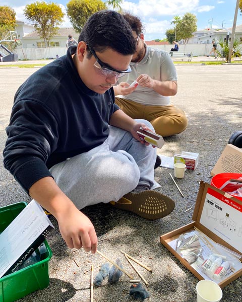 AHSA students doing a chemistry experiment outdoors