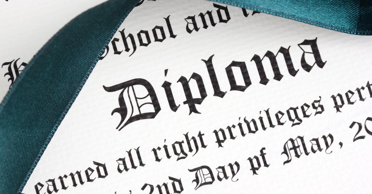 Cropped image of a diploma with a ribbon on it